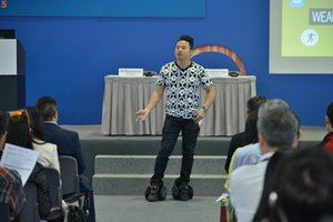 Photo: Wayne Leung modelling smart electric skates at the seminar.
