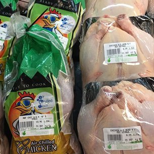 Photo: Halal chicken and non-halal chicken on display side-by-side in a Malaysian supermarket. Photo: Halal chicken and non-halal chicken on display side-by-side in a Malaysian supermarket.
