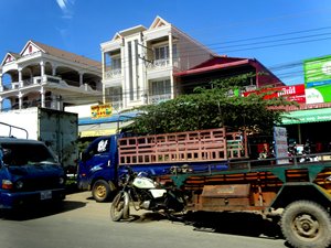 Photo: Trucks driving down a street in Phnom Penh. Photo: Trucks driving down a street in Phnom Penh.